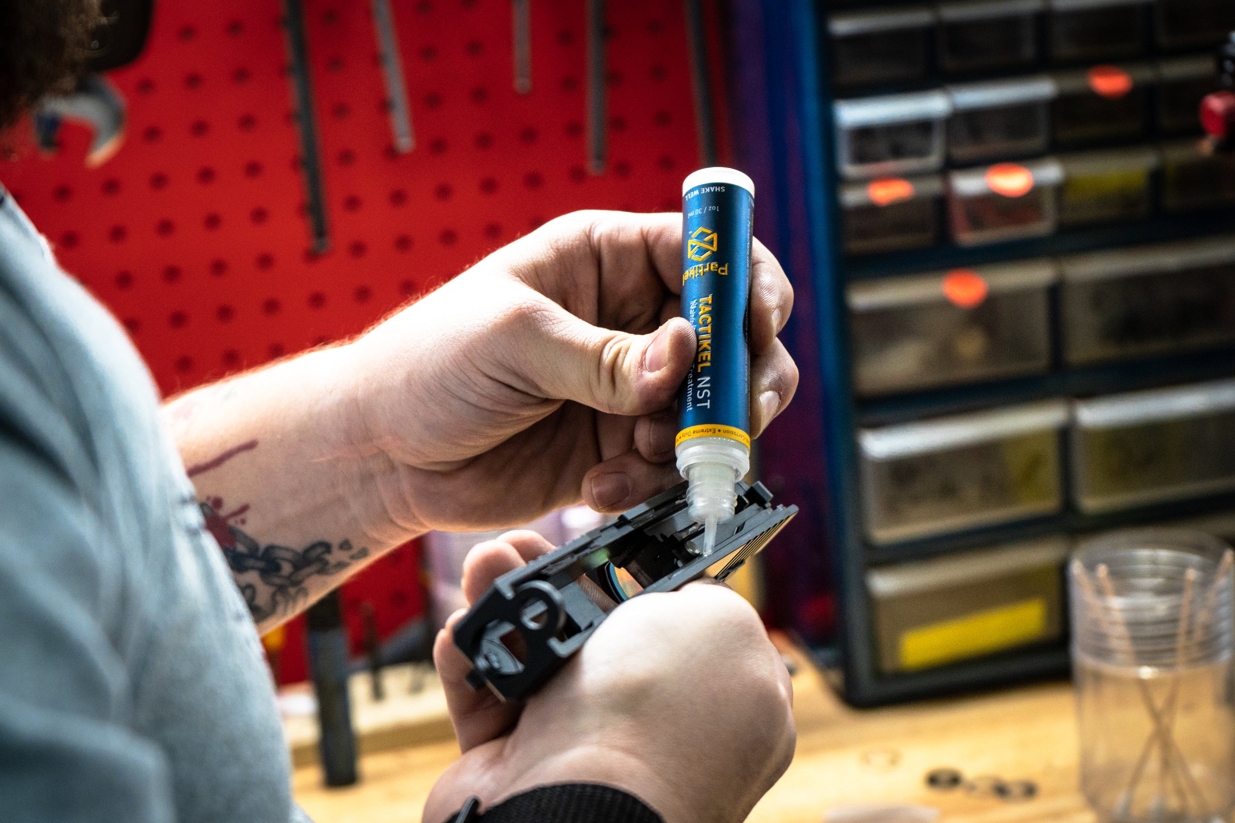Gunsmith at Lone Star Armory applying Tactikel NST to a pistol.