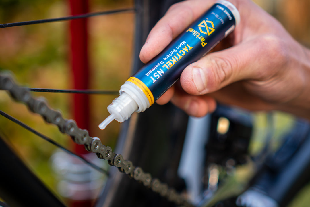 Applying Tactikel NST nano ceramic lubricant to a bicycle chain for reduced friction and wear